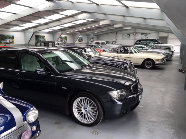A row of old cars inside a building